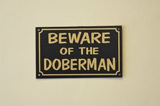 BEWARE OF THE DOBERMAN sign or